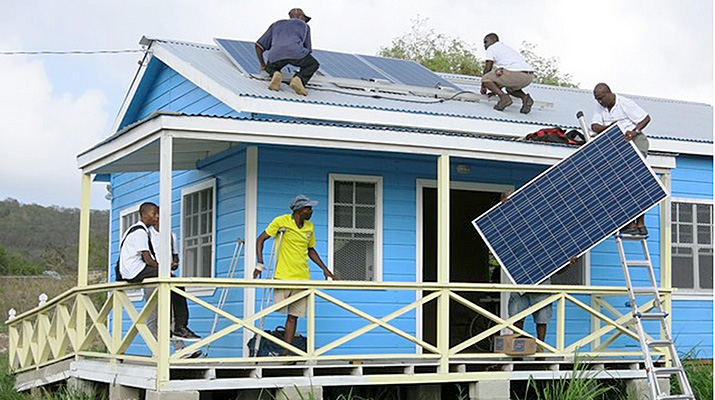 mens installing solar panels on a house